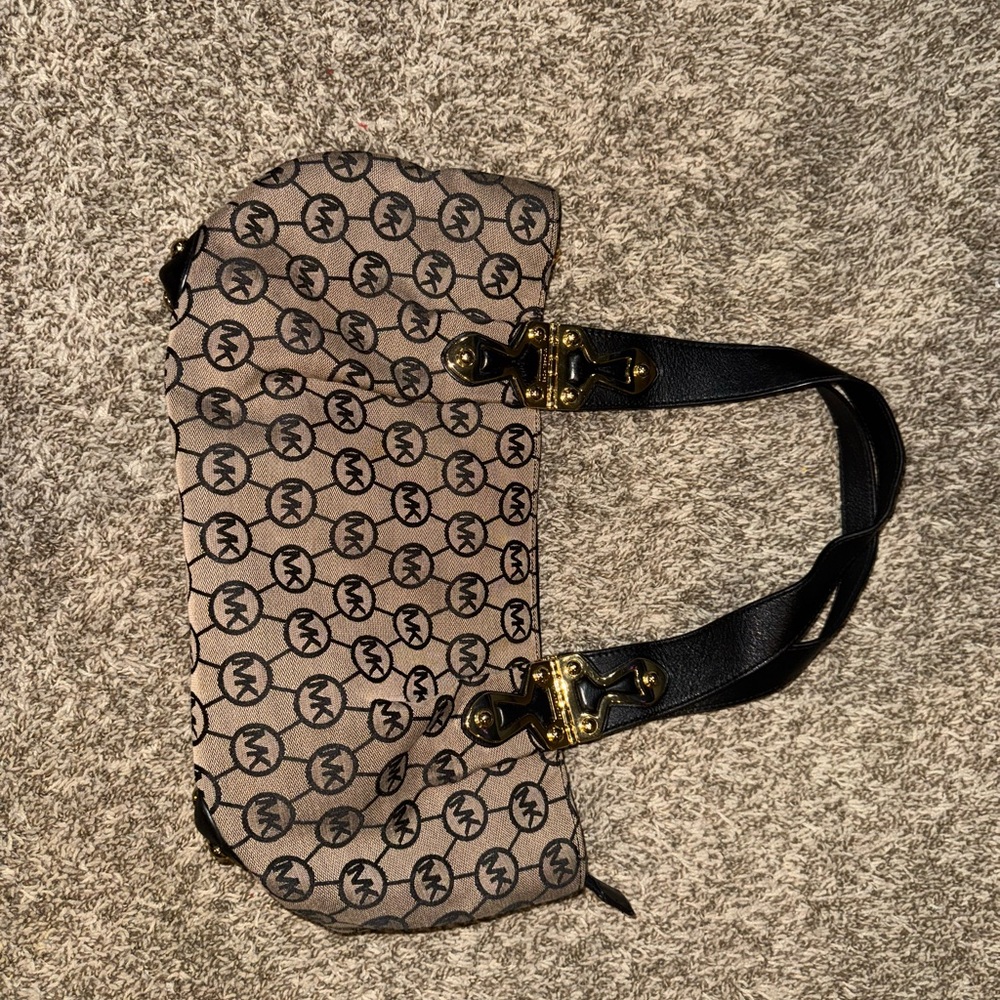 Elegant Black and Tan Satchel with Monogram Pattern